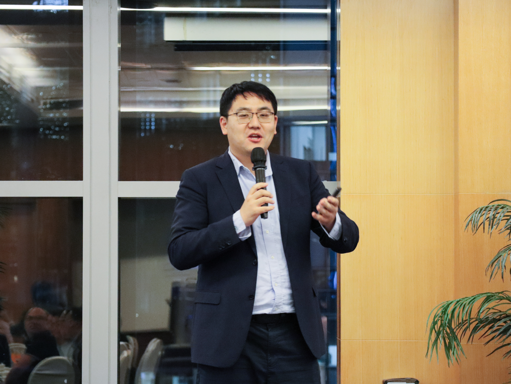 Leo Liu, Business Development Manager at TG Group, speaking at the event with a microphone, sharing insights about the company’s four main lines of business: contract staffing, recruitment, payroll process outsourcing (PPO), and global employer of record (PEO/EOR).