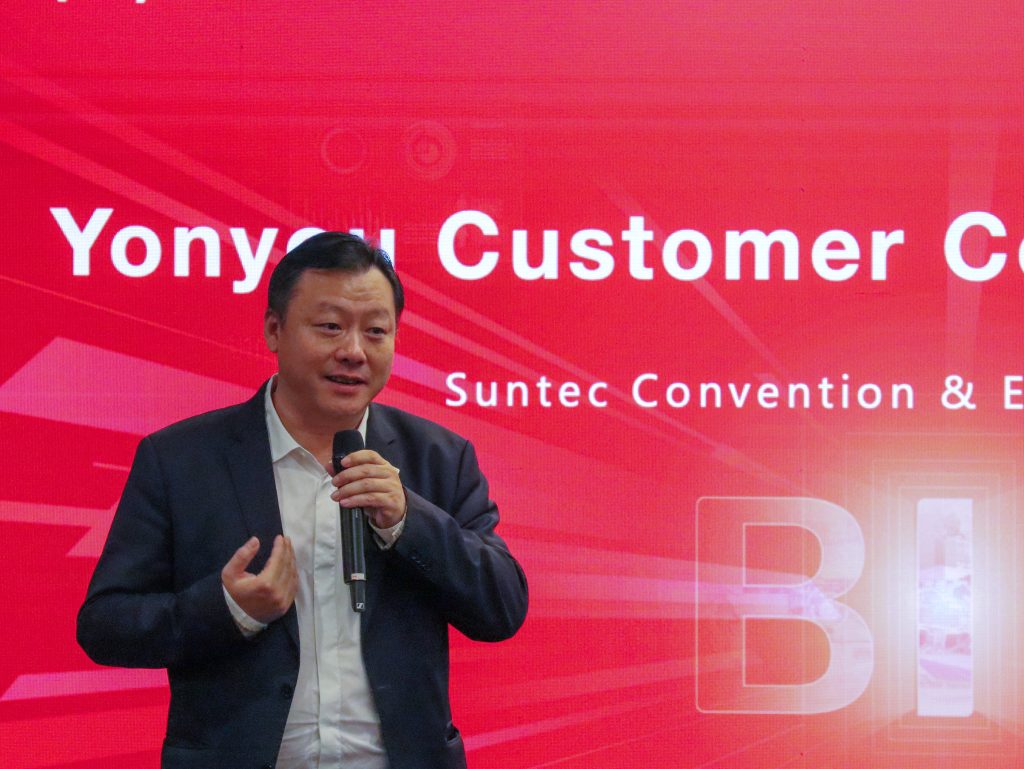 Howard Chen, Managing Director of Yonyou Network Technology (Singapore), delivering the welcome address on stage to open the Yonyou Customer Connect SEA 2024 event. The backdrop features an opening PowerPoint slide setting the tone for the event.